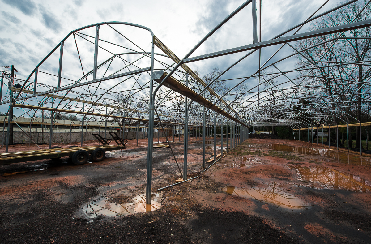 You can get an idea of the size of these three connected hoop houses here. It also tells you how the wet weather has slowed construction down considerably.
