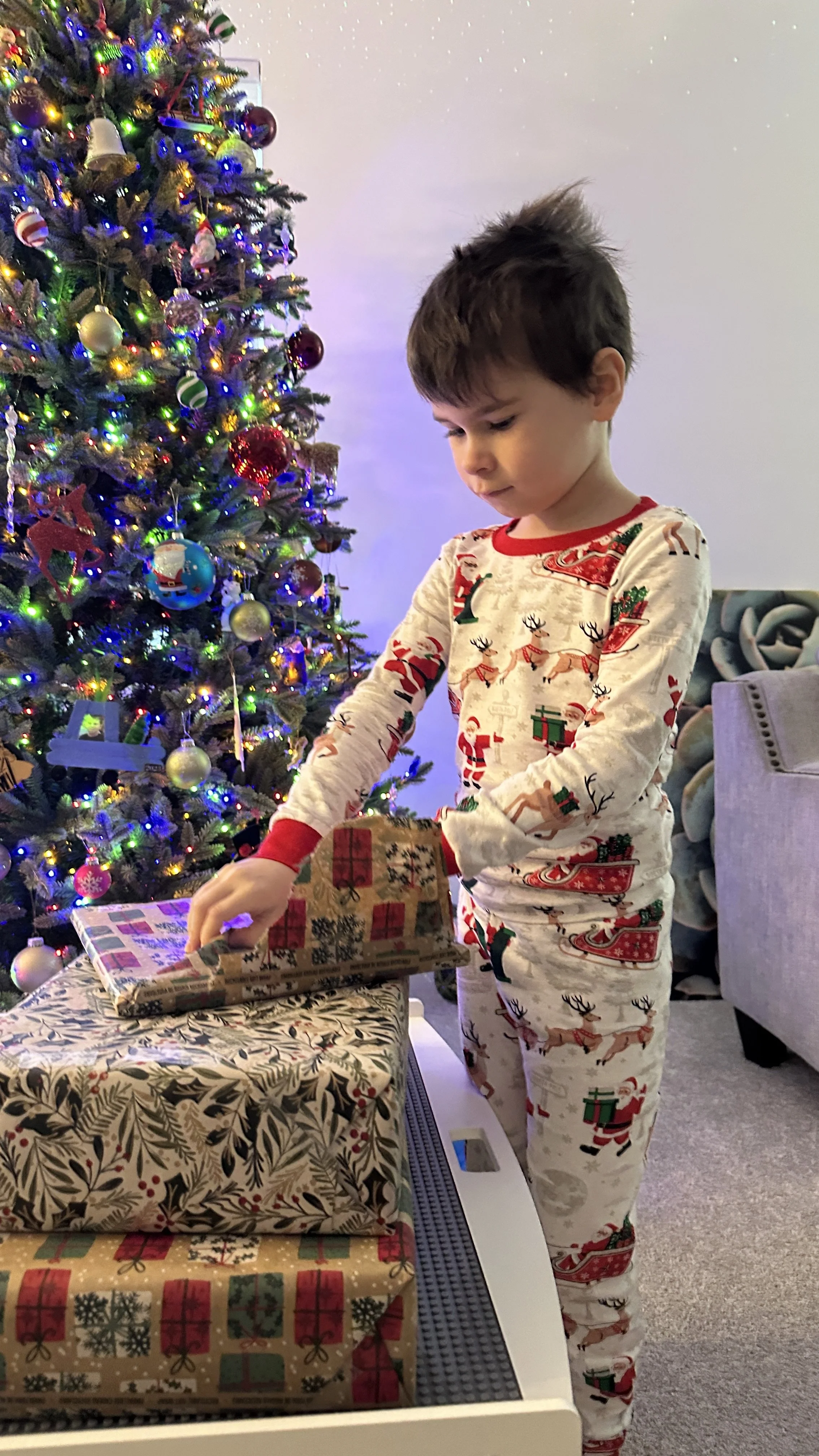 Isaac opening presents on Christmas morning at home