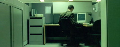 Neo at work, in his cubicle.