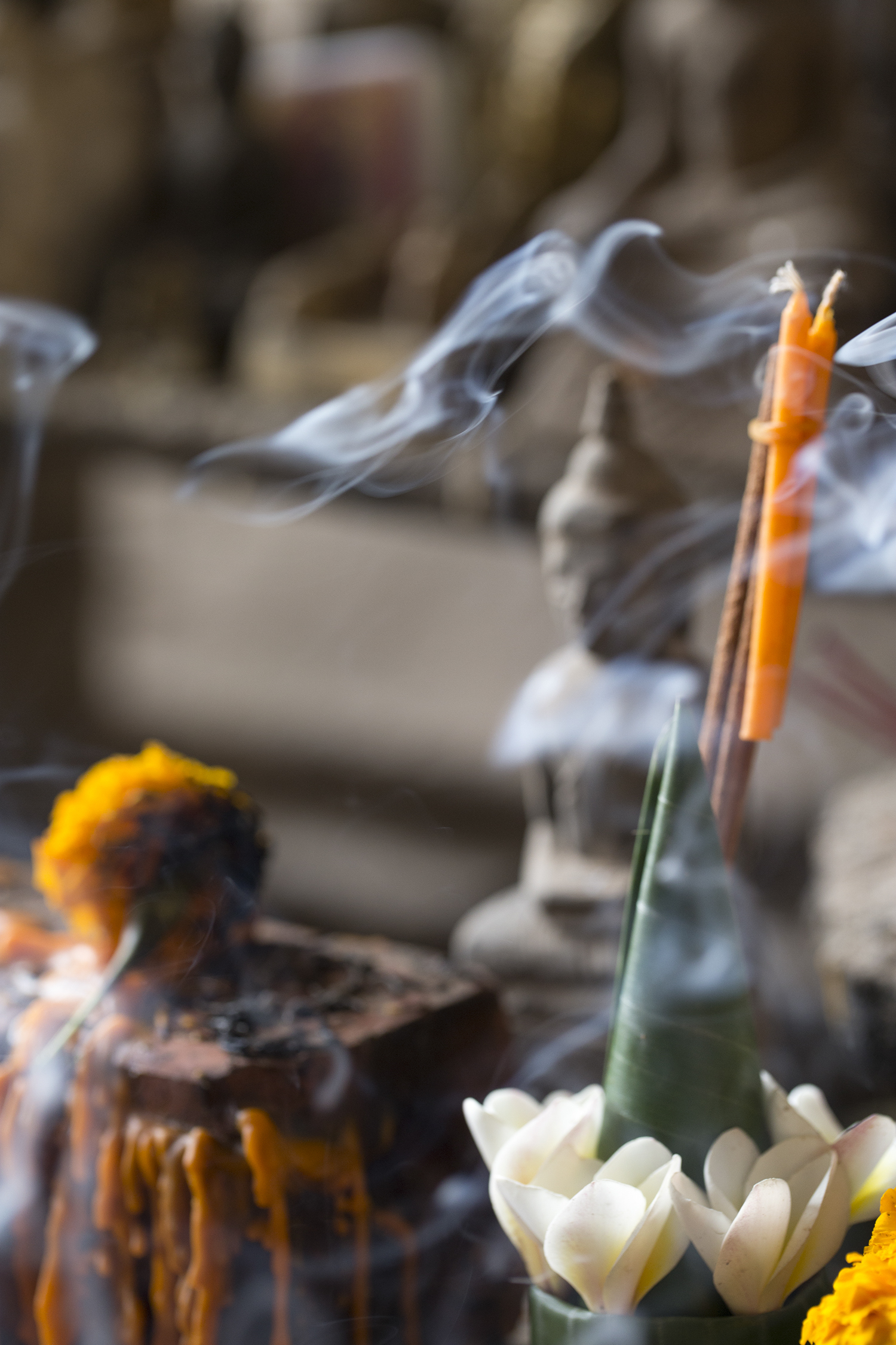 Julie Cimpko - An offering in the Pak Ou Caves in Laos, north of Luang Prabang. The caves are a sacred site holding thousands of Buddha statues.