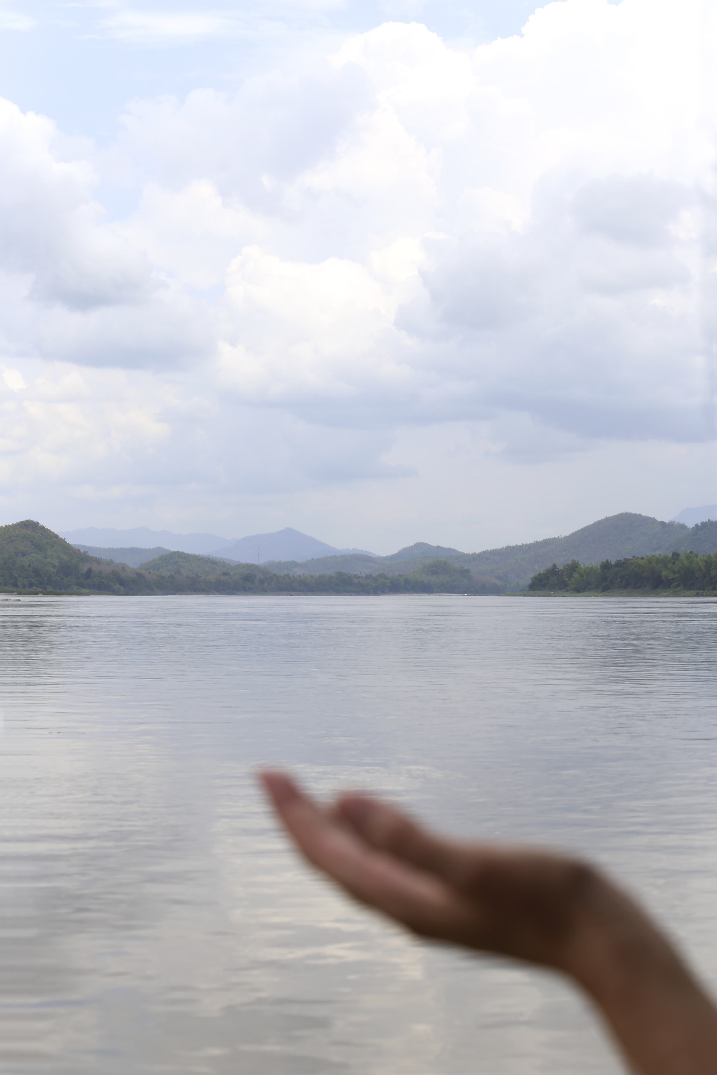 Michelle Larson - Awe... this photo was taken by Julie. I had my hand outside the boat to touch the cool breeze and the drops of rain that were beginning to fall... feeling so SERENE and blessed to be in the moment on the Mekong River in Luang Prabang, Laos. 