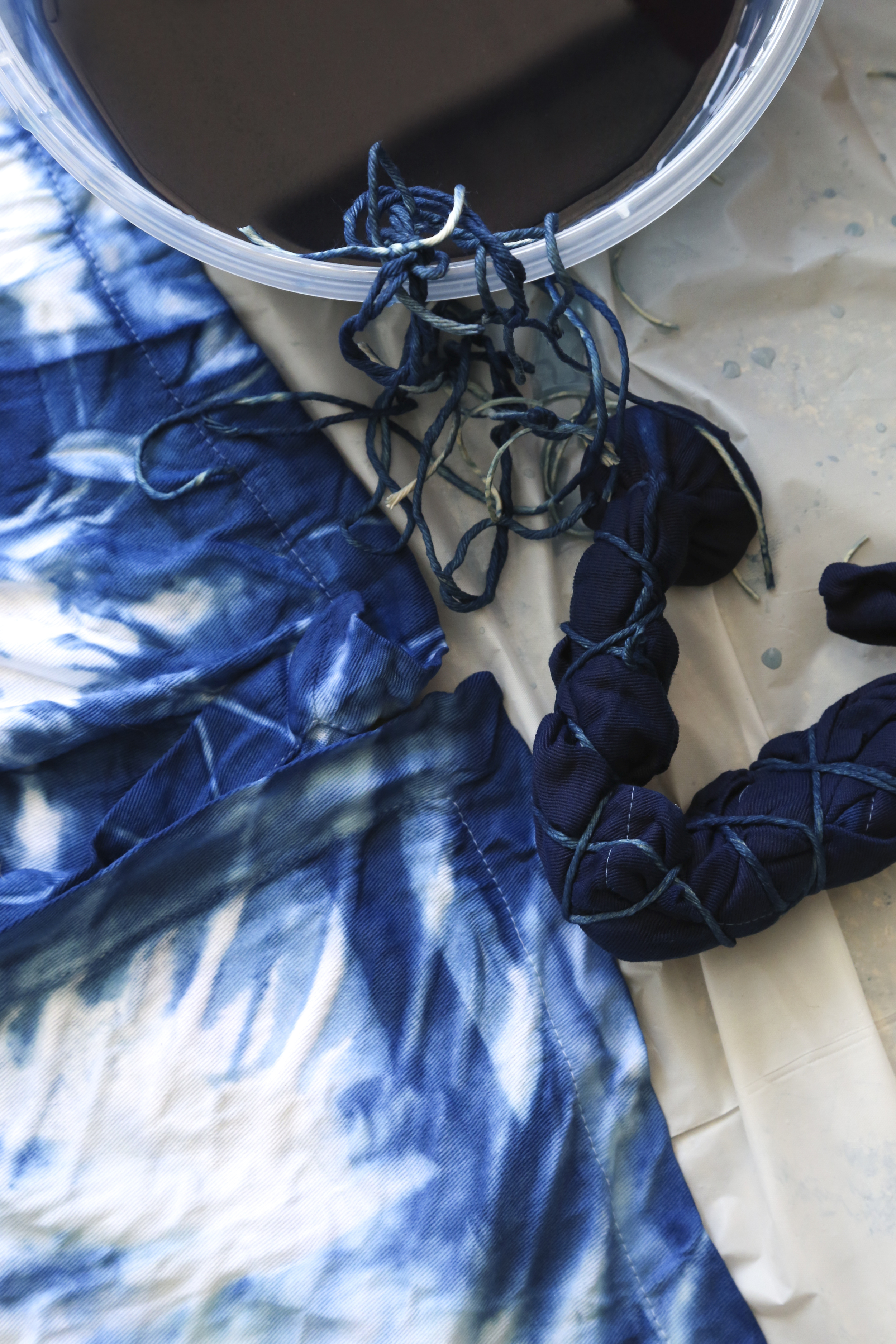 Susan Shepardson - Recently I learned about shibori - a Japanese dying technique that dates back to the 8th century. The main dye used in shibori is indigo which happens to be my favorite color so naturally I wanted to try it. I gathered all of the necessary materials and asked my friend Michelle to join me. We had so much fun creating napkins, tea towels and tank tops. The process is real open ended and produces unexpected and beautiful patterns. It's fun and easy to do; now my head is swimming with shibori ideas.