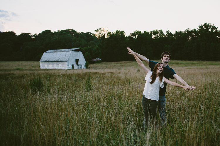 Playful Engaged Couple in Field