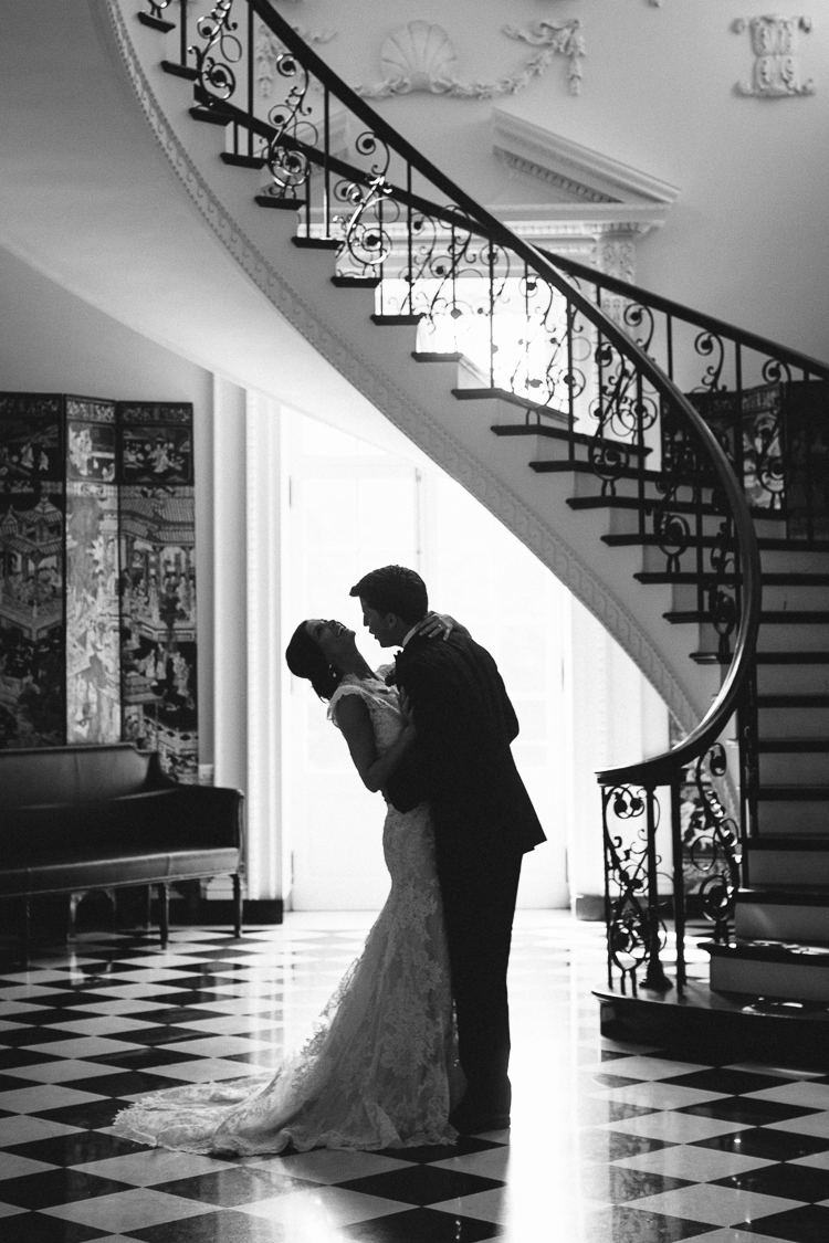 Black and White Bride and Groom Portrait Under Spiral Staircase