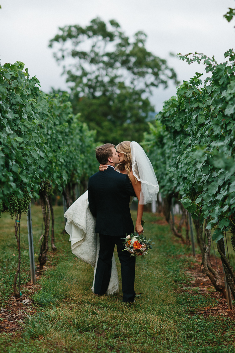 An Intimate Kiss Shared by the Bride and Groom in the Wolf Mountain Vinyard