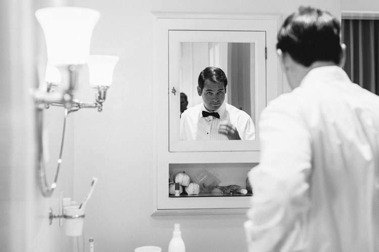 Black and white groom reflection portrait