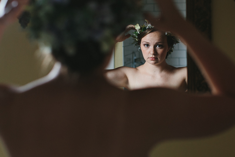 Bride putting on her floral crown