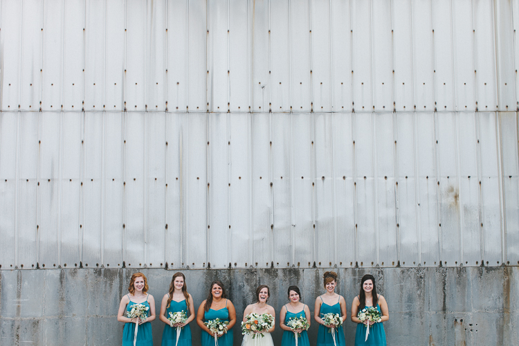 Bride and bridesmaid laughing in straight line