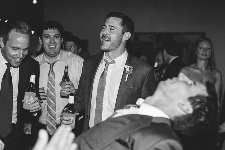 Groom and groomsmen dancing at reception