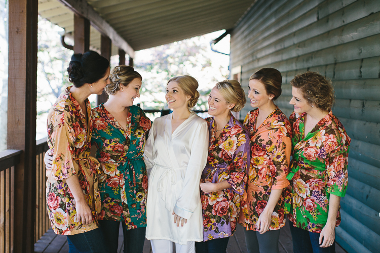 Bride and her bridesmaids getting ready in their floral robes