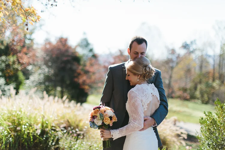 Groom kissing his bride on the head
