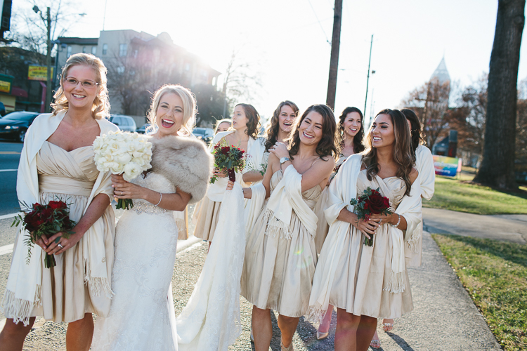 bride and her bridesmaids walking down the street together