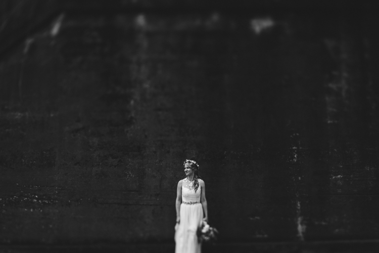 bohemian bride by concrete wall