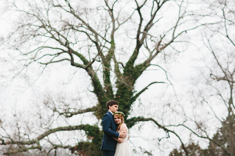 bride and groom in front of huge tree