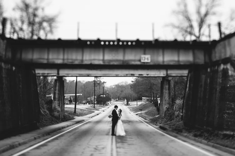 bride and groom under bridge