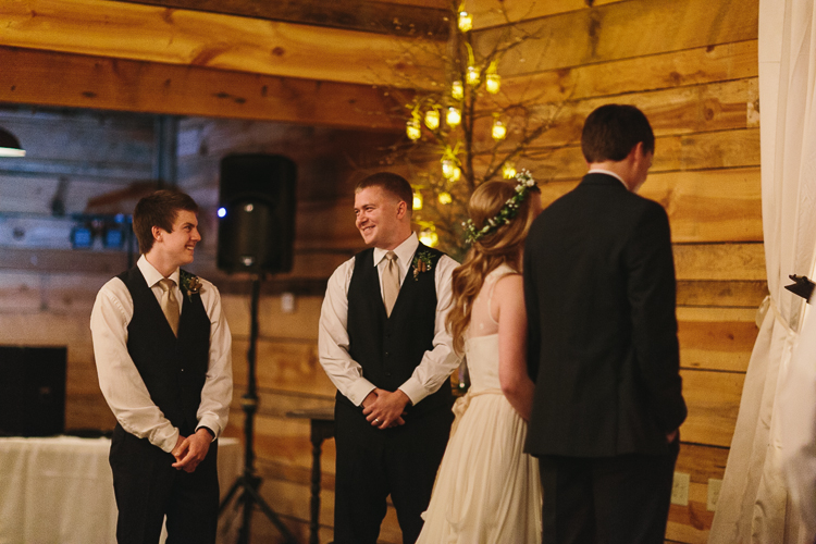 brothers share a smile while their sister gets married