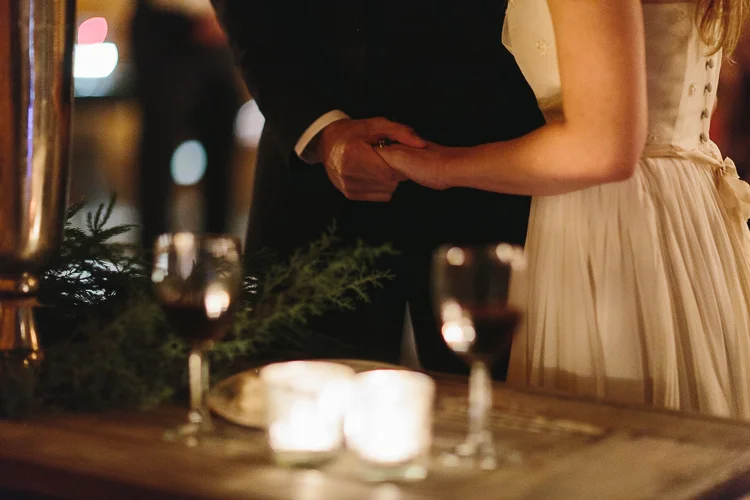 bride and groom holding hands after taking communion