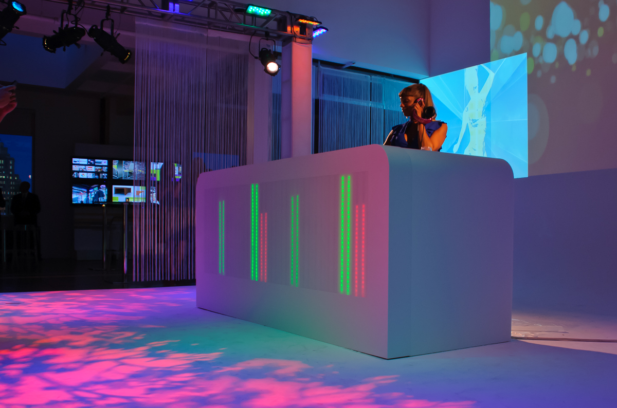 Backlit LED display moves up and down to the music in this DJ booth. Design by Russ Perry - Keane Creative. Fabrication by Sterling Surfaces. Photo by Jeff Baumgart.