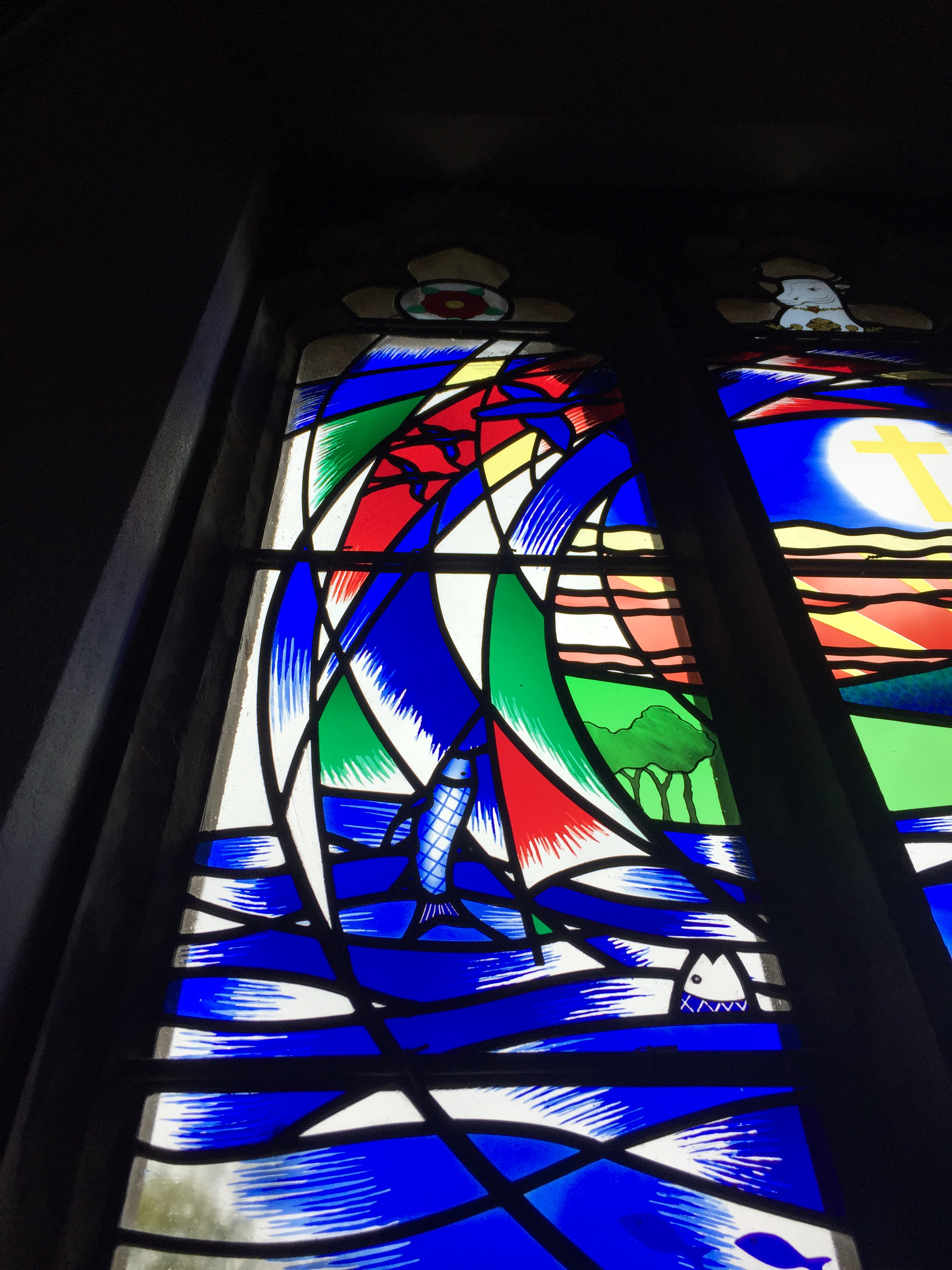 Stained glass fish and birds in Eridge Church window