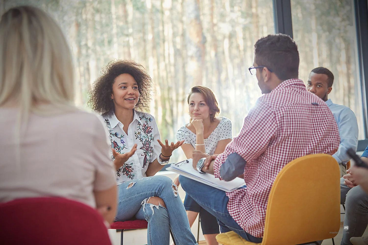 Women talking in group therapy session © Masterfile - Person(s) appearing in the above photograph are models and used for illustrative purposes only.