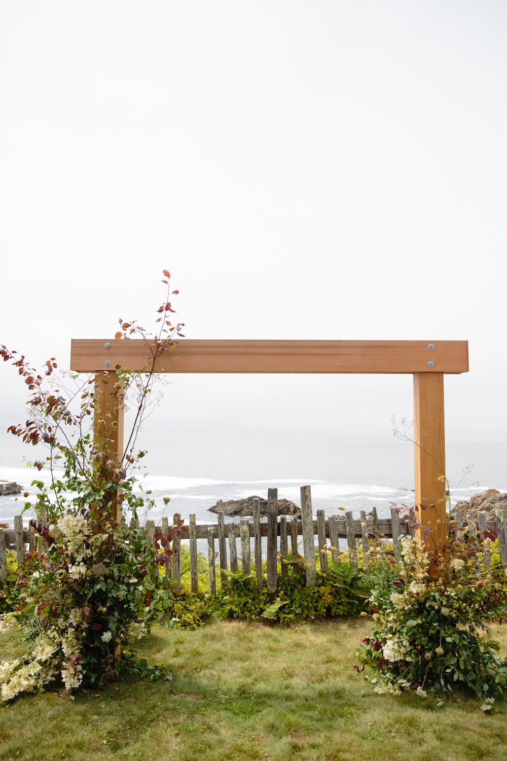  Our architect groom built this arbor, framing the iconic California coast at Sea Ranch.  Photo by Larissa Cleveland.  Event Design by DALD Events. 
