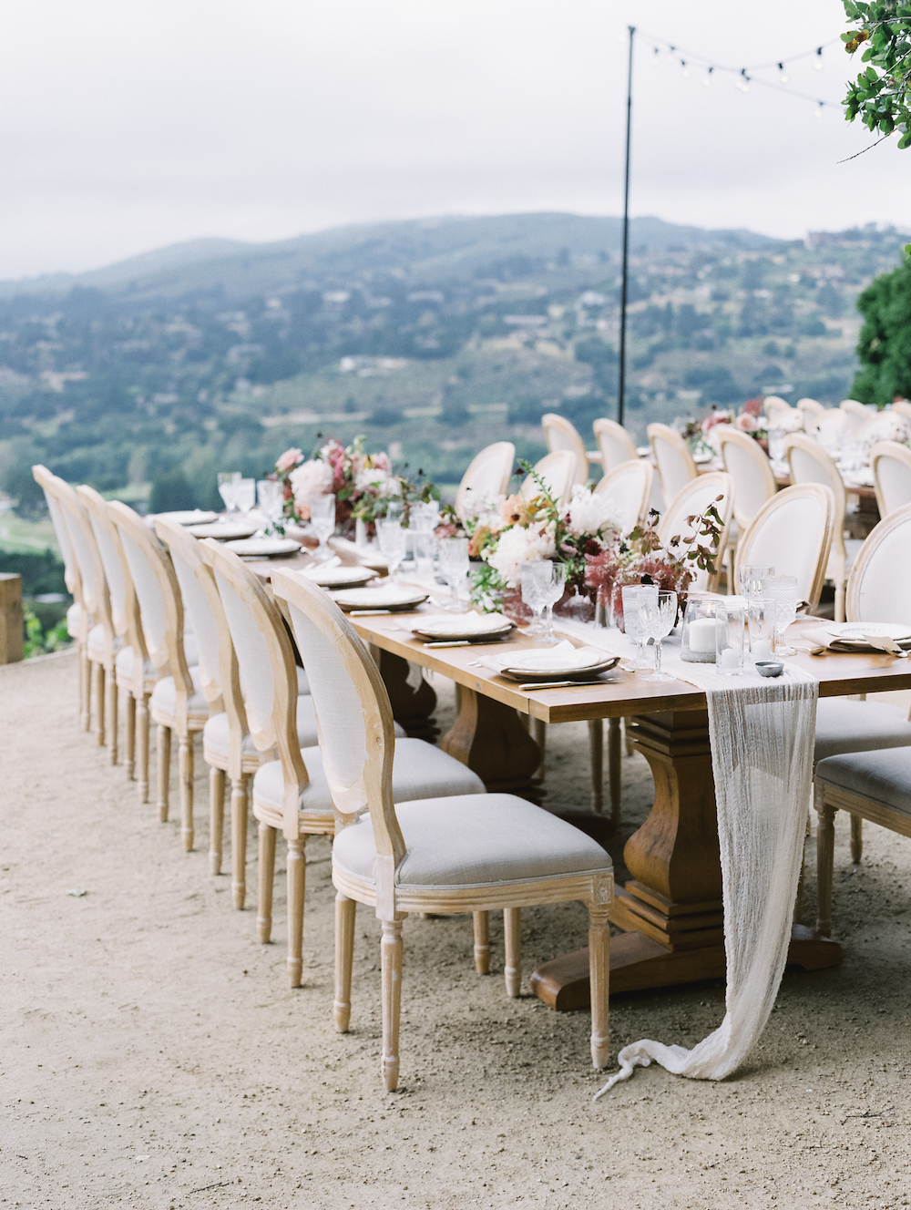 We suggested this dining configuration so each guest had a view of the valley beyond. Environment, atmosphere, and experiential design are everything.  Photo by Michele Beckwith. Event design by Lambert Floral Studio. 