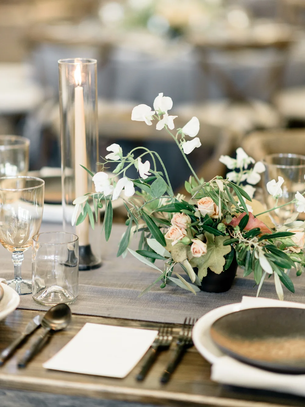 A sleek tabletop calls for finessed flowers with gestural and lyrical movement. Photo by Taralynn Lawton. Event Design by Jenny Schneider Events.