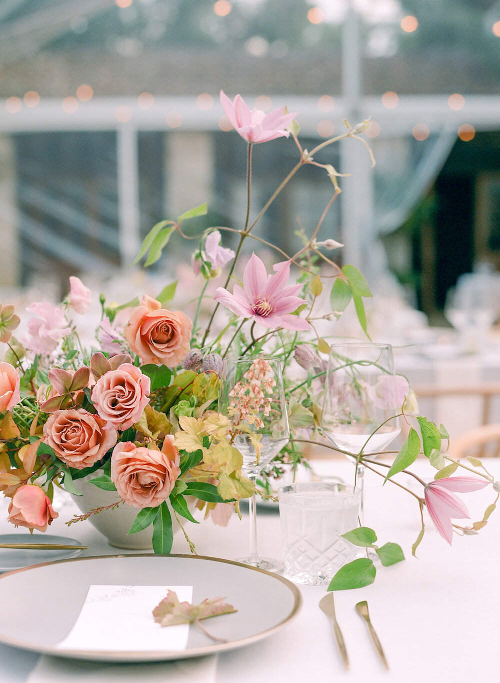  This wedding was in the latter half of May, affording us the unique blend of late spring (hellebore! frittilaria meleagris! heucherella!) and early summer (garden roses! clematis! sweet pea!) blooms.   Photo by Amanda Crean. Event Design by Natalie 