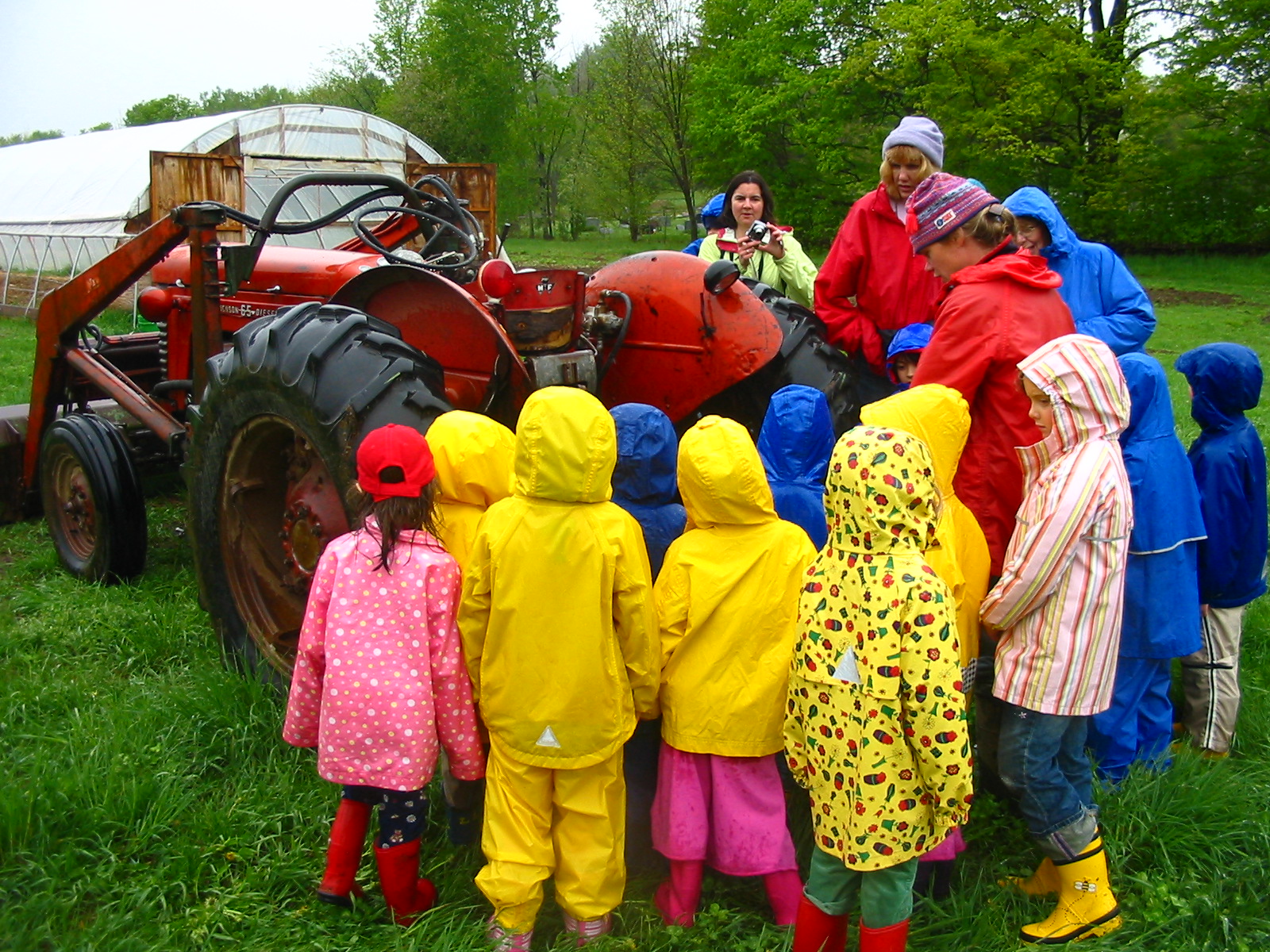 Christa shows aspiring farmers from Saxon Hill School how the tractor works.
