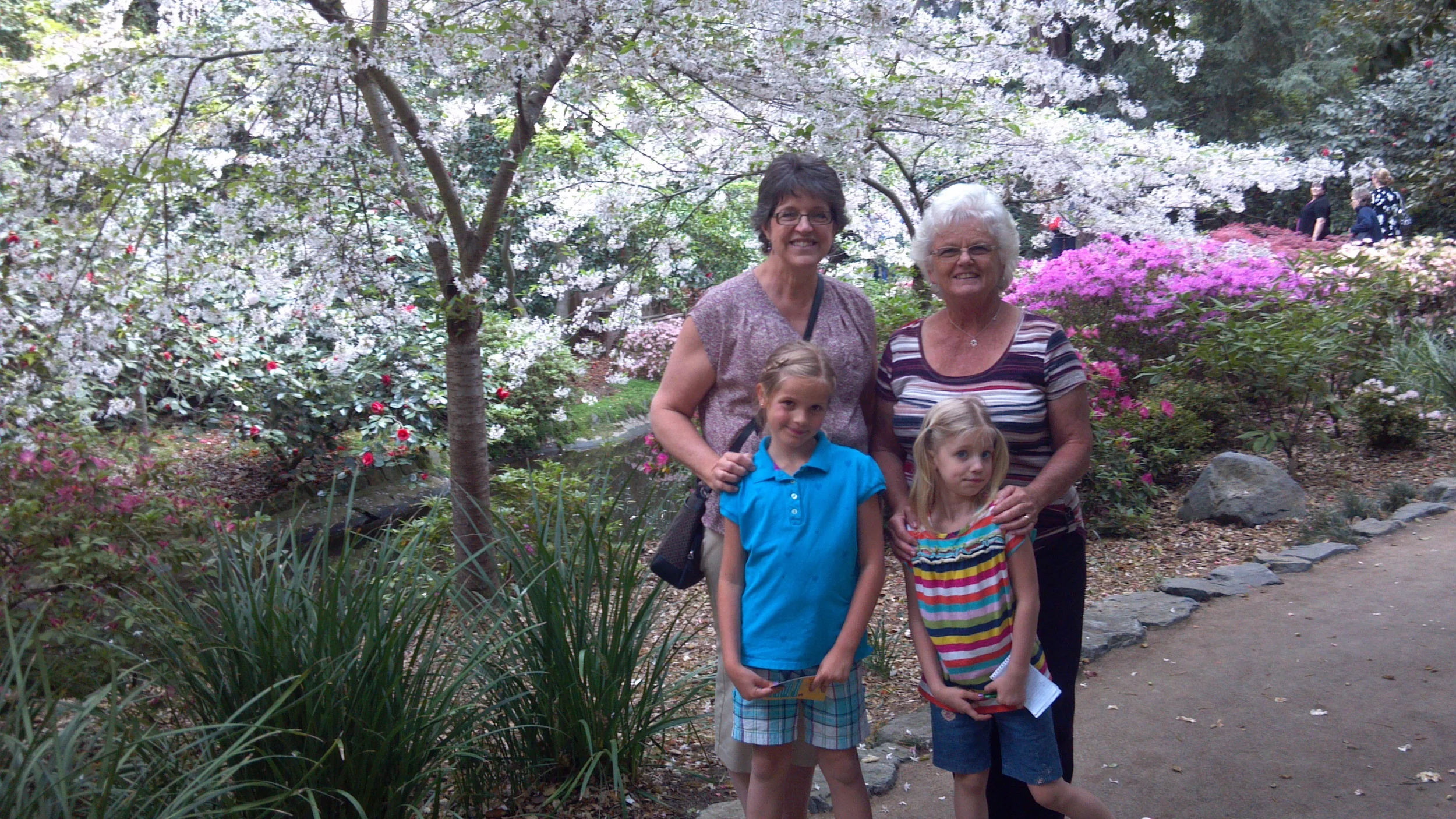 Grandmas and Granddaughters under a floral canopy
