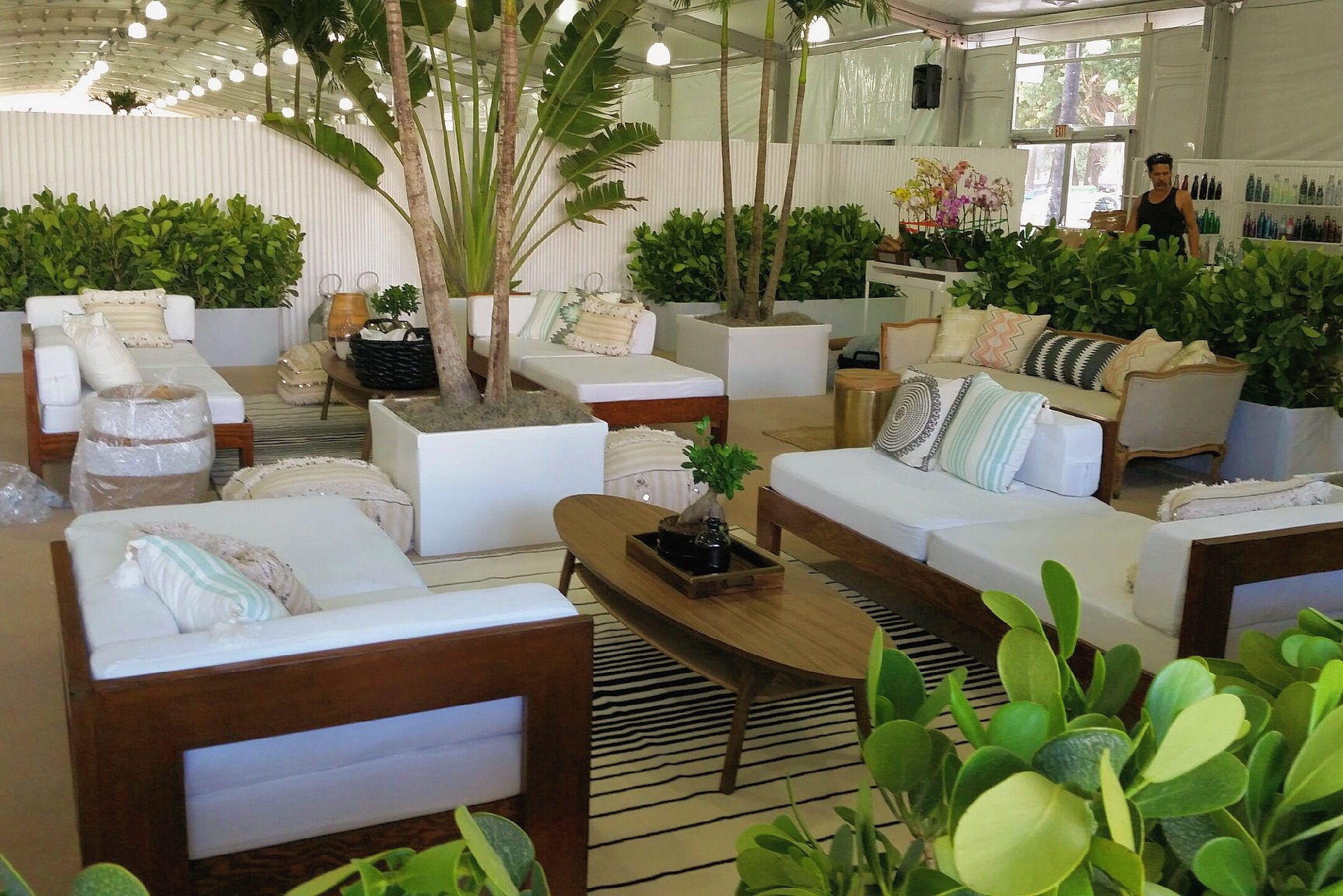 a mixture of plants and colorful pillows together with our lounge chairs at the Cabana show on Miami Beach.