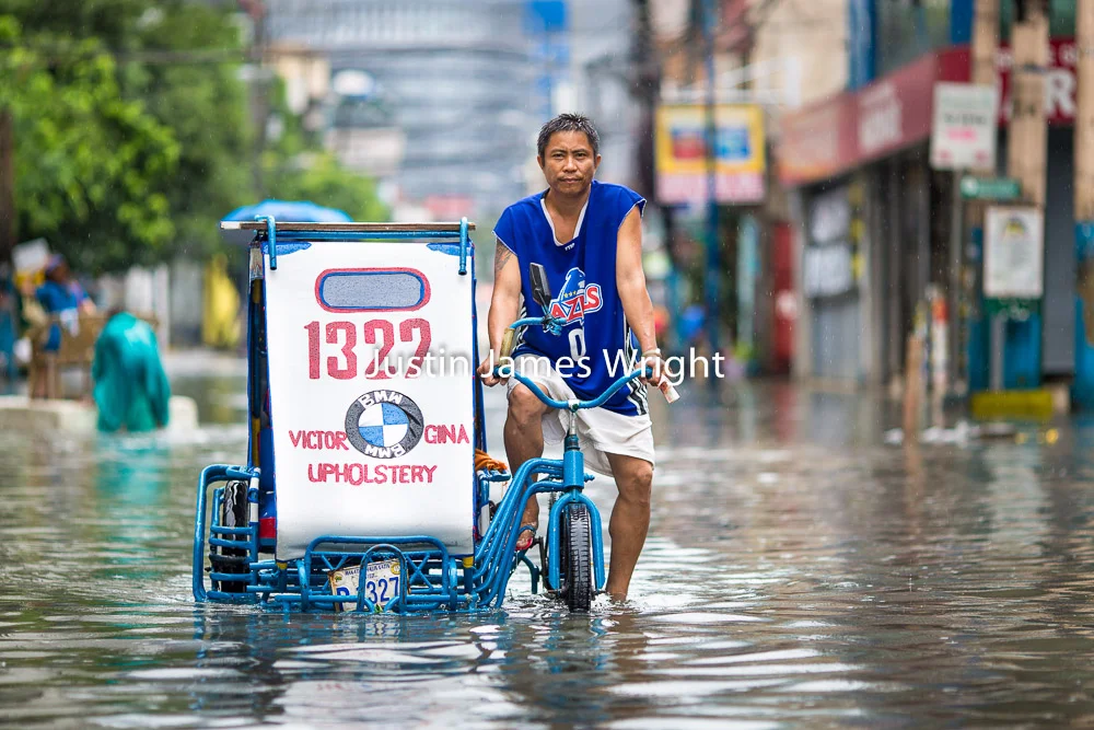 Tricycle on a Flooded Street, Makati City, Metro Manila, Philippines Philippine Image : 4127 If you wish to purchase a photography print of this image, or would like to license this image please contact us using the form below. Please kindly include the Image Title and Image Ref # in your message, we will get back to you.