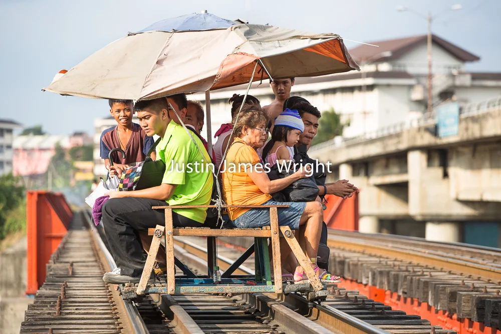 Philippines National Railways (PNR), Sta. Mesa, City of Manila, Passengers use a trolley, a mode of public transportation which runs on the railway tracks in between regular trains Philippine Image: 4106 If you wish to purchase a photography print of this image, or would like to license this image please contact us using the form below. Please kindly include the Image Title and Image Ref # in your message, we will get back to you.