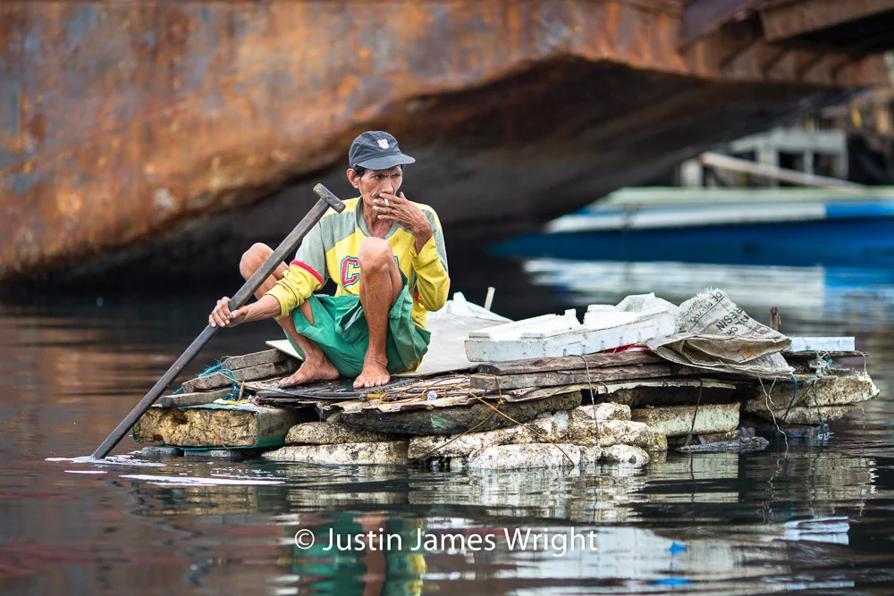 A Man Collects Garbage for Recycling, Navotas River, Navotas, Metro Manila, Philippine Philippine Photo # 4196 If you wish to purchase a photography print of this image, or would like to license this image please contact us using the form below. Please kindly include the Image Title and Image Ref # in your message, we will get back to you.