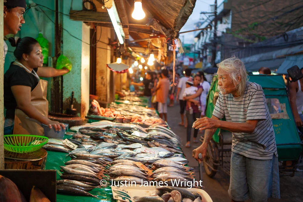 Fishy Guy - October 2011. Canon EOS 5D Mk II, EF 24 - 70 mm F2.8/L @ F2.8 - 35 mm, 1/100 sec. From the Photographic Story : A Decade on One Street.