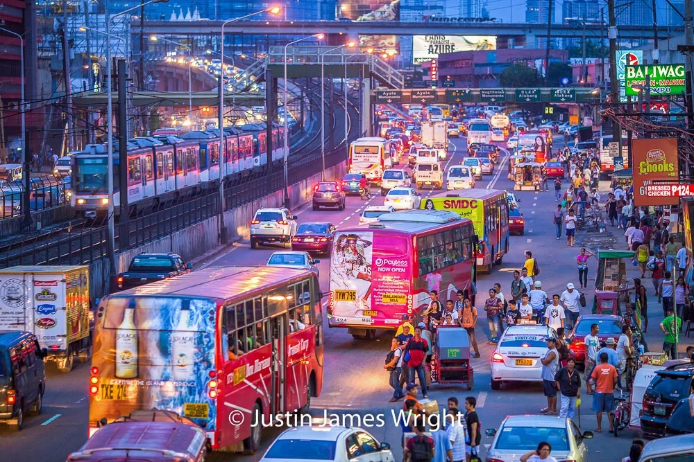 EDSA and the entrance into P. Santos Street on the right handside - Feb 2012. Canon EOS 5D Mk II, EF 135 mm F2L / @ F2.0, 1/30 sec. From the Photographic Story : A Decade on One Street.