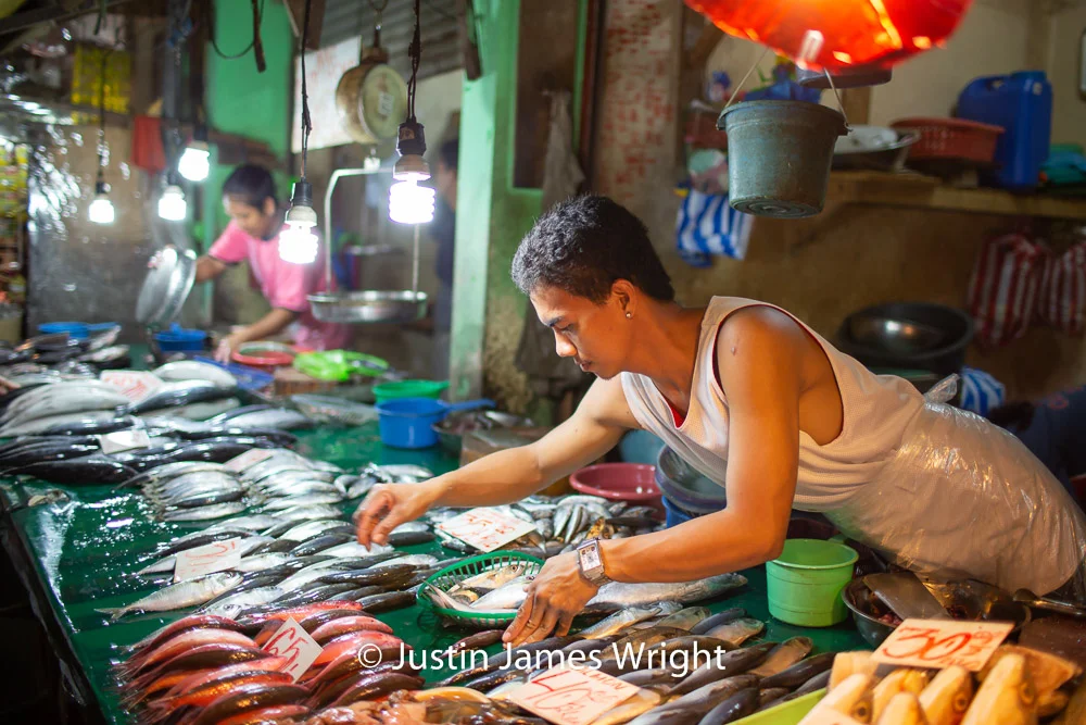 Fish Vendor - June 2013. Canon EOS 5D Mk III, EF 35 mm F1.4L. @ F1.4, 1/125 sec. From the Photographic Story : A Decade on One Street.