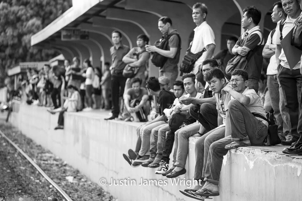 Commuters waiting for a train at Buendia station Makati City, Metro Manila, Philippines. Canon EOS Mk III, EF 70 - 200 mm, F 4.0, 1/250 sec.