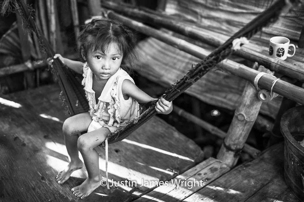 Rhea May Left to her own devices, Rhea May swings to her 4-year-old heart’s content. Resilience - The Isla Pulo Community, Philippines. July 2013. Canon EOS Mk III, EF 35 mm, F 2.0, 1/250 sec.