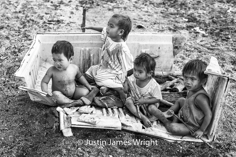 All Hands on Deck On board their ship – an old refrigerator washed ashore – Ramil Jr., Sael, Macoy, Rodel sail on the seas of imagination; mateys in work and play. Resilience - The Isla Pulo Community, Philippines. January 2013. Canon EOS Mk III, EF 50 mm, F 2.8, 1/640 sec.