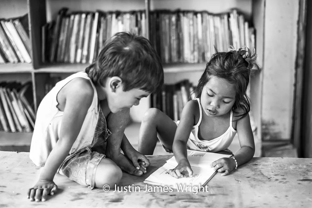 Learning to Read The Isla Pulo Community, Metro Manila, Philippines. February 2013. Canon EOS Mk III, EF 50 mm, F 2.0, 1/160 sec.