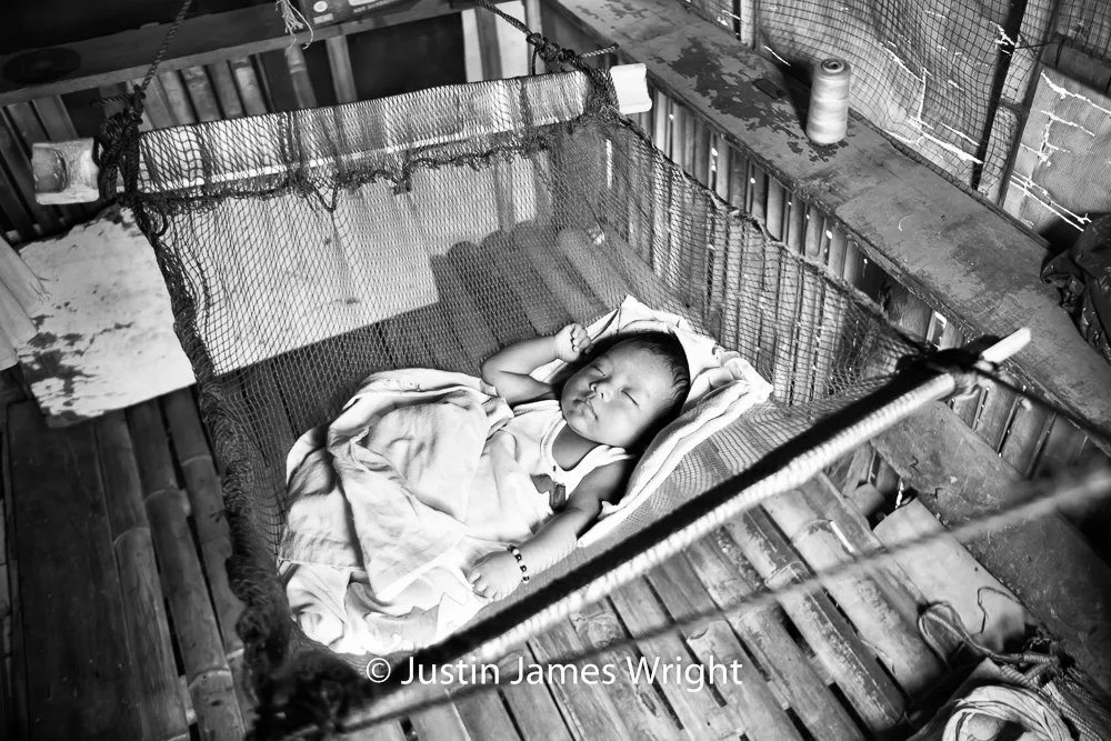 Baby Justine takes a morning nap. The Isla Pulo Community, Metro Manila, Philippines. January 2013. Canon EOS Mk III, EF 24 -70 mm, F 2.8, 1/100 sec.