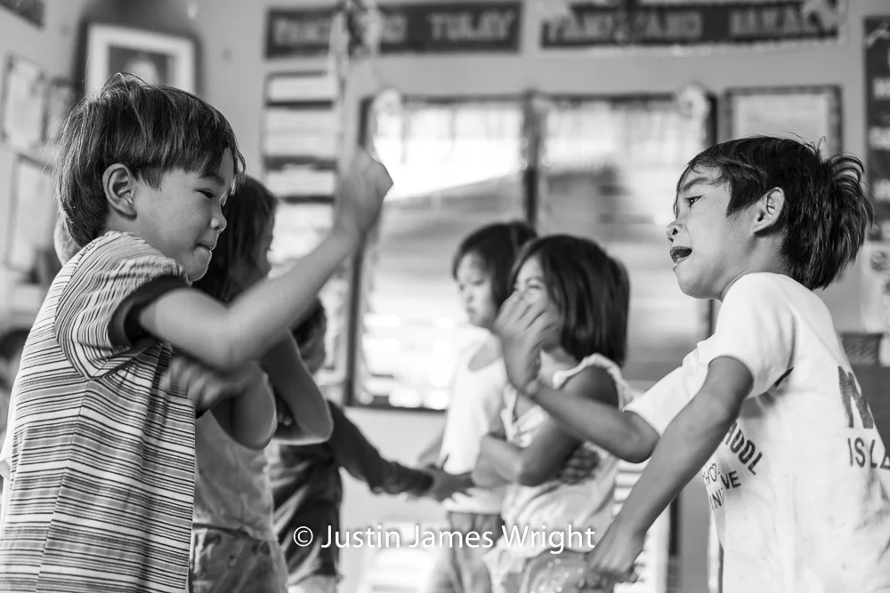 Children Enjoying Time in the Classroom Resilience - The Isla Pulo Community, Philippines. January 2013. Canon EOS Mk III, EF 50 mm, F 2.8, 1/160 sec.