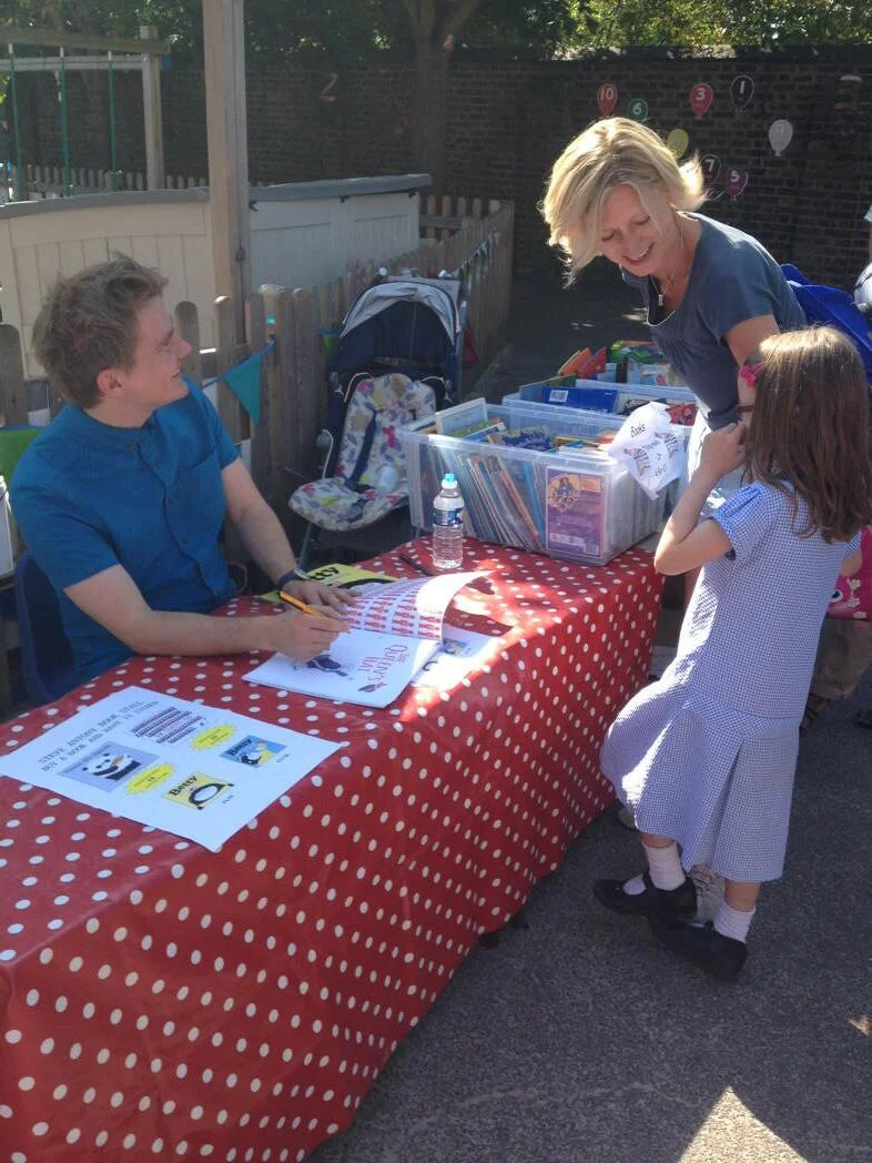 Signing books and chatting with parents and pupils. (Photo by Emerson Wimsey)