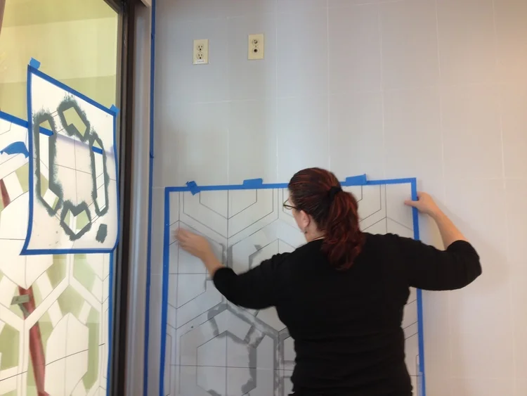 Lynne hanging first template after chalking off the pattern layout.