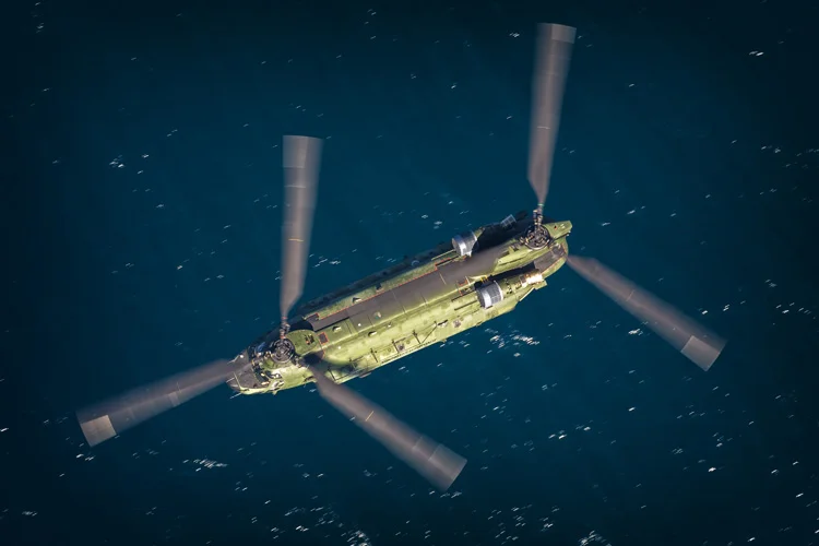 RNLAF CH-47D over the ocean during a mission on the range.