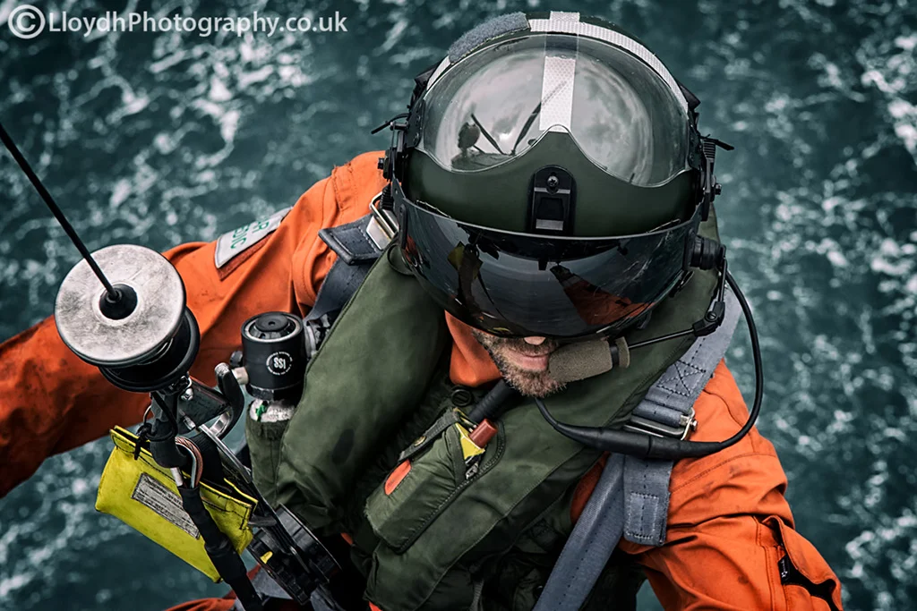 771 NAS Aircrewman reaches out for the grab handle as the winch operator brings him back up to the aircraft. 