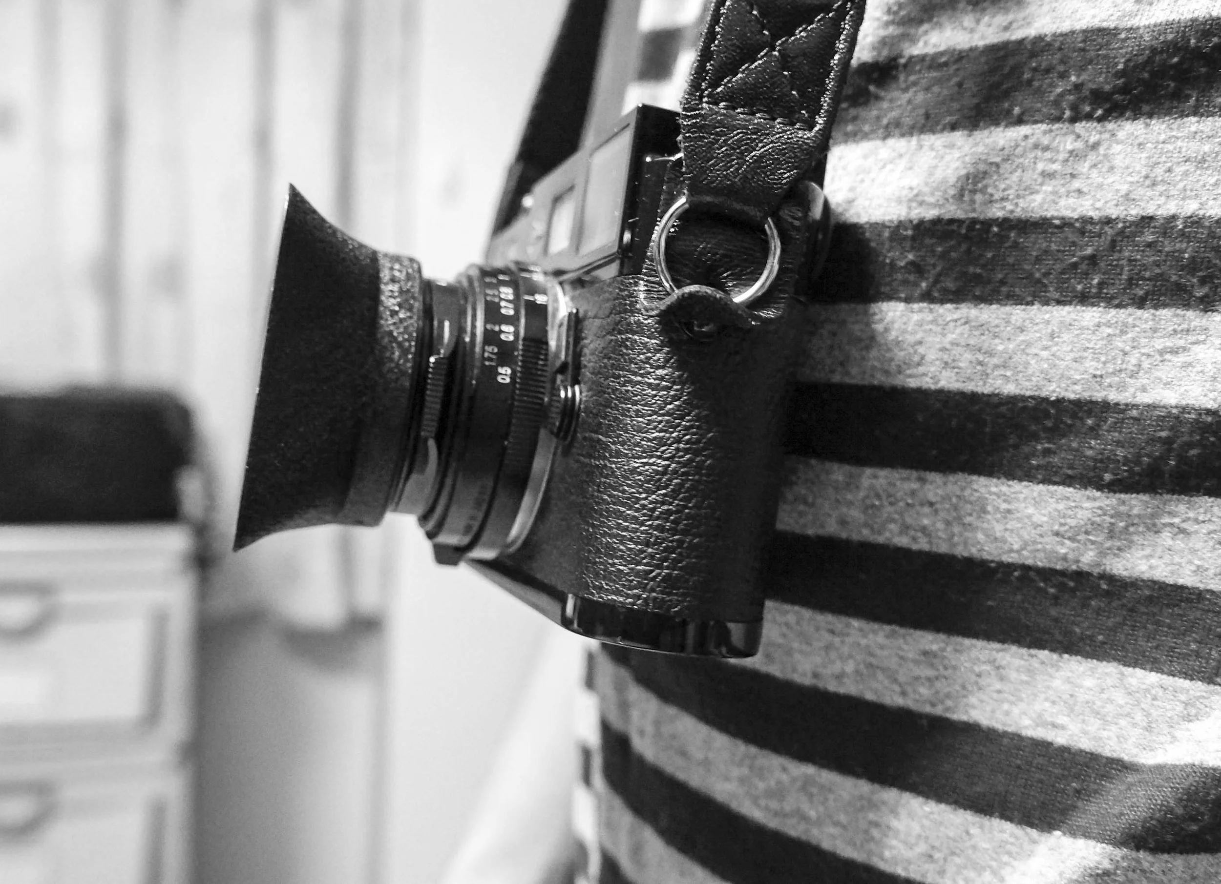 M6 rests flat on my body when hung from the neck