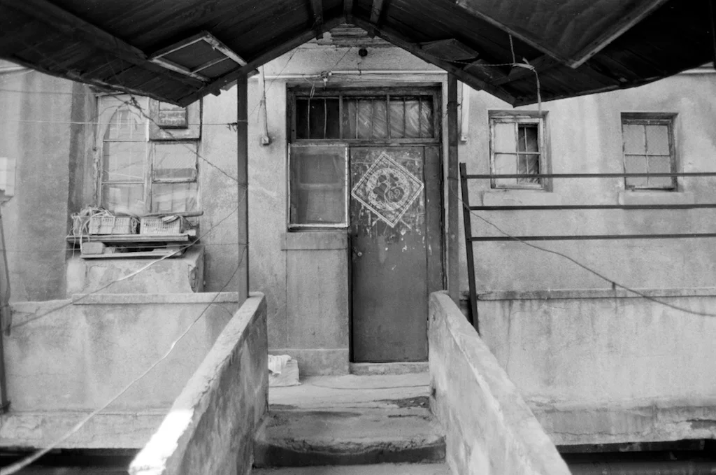 An Old Apartment | Fm2n with 28mm Itorex + Ilford Pan 100 | by Xue Rui