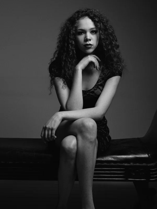 1 light setup. Softbox placed to camera right. No fill light. Note the deep shadow in the camera left side of her face. Ilford Pan F Plus.